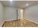 Bedroom with hardwood floors, neutral color scheme, and doorway leading to an adjacent room at 634 Sandpiper Cv, Stockbridge, GA 30281