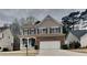 Charming two-story home featuring a brick and siding exterior, complemented by a well-maintained front yard and two-car garage at 634 Sandpiper Cv, Stockbridge, GA 30281