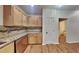 Well-equipped kitchen featuring granite countertops, wooden cabinetry, stainless steel appliances, and wood flooring at 634 Sandpiper Cv, Stockbridge, GA 30281