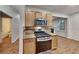 Modern kitchen offering granite countertops, wood cabinets, stainless steel appliances, and a seamless transition to the living area at 634 Sandpiper Cv, Stockbridge, GA 30281