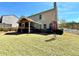 Expansive backyard featuring a screened porch, landscaping, and a well-maintained lawn at 1002 River Plantation Drive, Woodstock, GA 30188