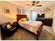 Comfortable carpeted bedroom features ceiling fan and large window offering plenty of natural light at 1002 River Plantation Drive, Woodstock, GA 30188