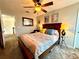 Cozy bedroom features ceiling fan, a large window, and a comfortable king sized bed at 1002 River Plantation Drive, Woodstock, GA 30188