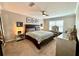 Relaxing bedroom with a ceiling fan, queen-size bed, and a vanity area at 1002 River Plantation Drive, Woodstock, GA 30188