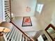 Bright entryway showcasing a chandelier, a poster and the wooden staircase to the second floor at 1002 River Plantation Drive, Woodstock, GA 30188