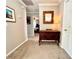 Cozy hallway with wooden furnishings, neutral-toned carpet, and a view into a bedroom at 1002 River Plantation Drive, Woodstock, GA 30188