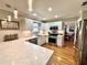 Bright kitchen features white cabinets, stainless steel appliances, and hardwood floors at 1002 River Plantation Drive, Woodstock, GA 30188