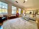 Open living room with large windows, hardwood floors, and access to the kitchen at 1002 River Plantation Drive, Woodstock, GA 30188