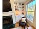 Cozy reading nook with fireplace, built-in shelving, and natural light at 1002 River Plantation Drive, Woodstock, GA 30188