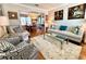 Living room with hardwood floors, sofa, chairs, and view to the dining room at 1002 River Plantation Drive, Woodstock, GA 30188