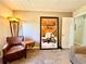 Inviting living room with a comfortable leather chair, unique floor lamp and movie poster at 1002 River Plantation Drive, Woodstock, GA 30188