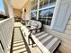 Covered porch with seating and neutral decor at 1002 River Plantation Drive, Woodstock, GA 30188