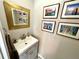 A charming powder room with modern vanity and unique art at 1002 River Plantation Drive, Woodstock, GA 30188