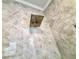 Shower featuring a rainfall shower head and neutral-toned marble-like tiling at 1002 River Plantation Drive, Woodstock, GA 30188