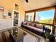 Bright sunroom with wicker furniture, featuring a glass coffee table, and a view to the outdoors at 1002 River Plantation Drive, Woodstock, GA 30188