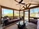 Relaxing sunroom with vaulted ceilings, lots of windows, and comfortable seating at 1002 River Plantation Drive, Woodstock, GA 30188