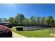 Community tennis court surrounded by lush greenery and a covered gazebo, offering a great recreational space at 1002 River Plantation Drive, Woodstock, GA 30188