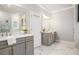 Bathroom featuring double sinks with white countertops, gray cabinets, and a large mirror at 3139 Hilltop Dr, Marietta, GA 30066