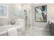 Modern bathroom with a soaking tub, glass shower, marble-like tiling and stylish decor at 3139 Hilltop Dr, Marietta, GA 30066