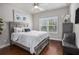 Cozy bedroom with hardwood floors, natural light, and a bed with a gray wooden frame at 3139 Hilltop Dr, Marietta, GA 30066
