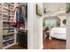 Walk-in closet filled with organized storage, connecting to the main bedroom with hardwood floors at 3139 Hilltop Dr, Marietta, GA 30066