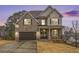 Charming two-story brick home with a manicured lawn and dark wood garage doors at 3139 Hilltop Dr, Marietta, GA 30066