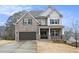 Charming two-story home with a brick facade, dark shutters, and a well-maintained front yard and driveway at 3139 Hilltop Dr, Marietta, GA 30066