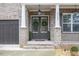 Inviting front entrance with double doors, a brick facade, a well-manicured yard and a two-car garage at 3139 Hilltop Dr, Marietta, GA 30066