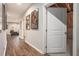 Hallway with hardwood floors, leading to a basement with unfinished walls and ceilings at 3139 Hilltop Dr, Marietta, GA 30066