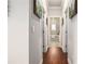 Hallway features hardwood floors, artwork, and doors leading to other rooms and a peek of the bathroom at 3139 Hilltop Dr, Marietta, GA 30066