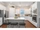 Bright kitchen with stainless appliances, white cabinets, and island with seating at 3139 Hilltop Dr, Marietta, GA 30066