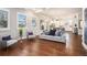 Open-concept living room with hardwood floors, modern decor, large windows, and seamless access to the kitchen at 3139 Hilltop Dr, Marietta, GA 30066