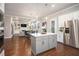 Open concept living room and kitchen with island, stainless appliances, and fireplace at 3139 Hilltop Dr, Marietta, GA 30066
