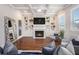 Bright living room with a fireplace, custom built-ins, hardwood floors, and modern decor at 3139 Hilltop Dr, Marietta, GA 30066
