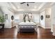 Bright main bedroom features a tray ceiling, hardwood floors, neutral walls, and abundant natural light from two windows at 3139 Hilltop Dr, Marietta, GA 30066