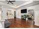 Spacious main bedroom features hardwood floors, a ceiling fan, flat-screen TV, and ample natural light at 3139 Hilltop Dr, Marietta, GA 30066