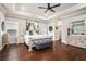 Beautiful main bedroom with neutral walls, hardwood floors, tray ceiling, ceiling fan, and a decorative, white wood bedframe at 3139 Hilltop Dr, Marietta, GA 30066