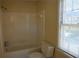 Full bathroom features a toilet, a shower, and a window for ventilation at 3338 York Pl, Decatur, GA 30032