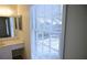 Bright bathroom featuring vanity with a sink, mirror, large window, and hardwood style flooring at 3338 York Pl, Decatur, GA 30032