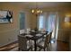 Charming dining area with a dark wood table set for six, a chandelier, and sunny window at 3338 York Pl, Decatur, GA 30032