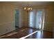 Charming dining area with a dark wood table set for six, a chandelier, and sunny window at 3338 York Pl, Decatur, GA 30032