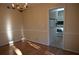 Cozy dining room featuring a dark wood table set for six, a chandelier, and view to the kitchen at 3338 York Pl, Decatur, GA 30032