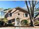 Traditional brick home with a symmetric facade, complemented by mature trees and manicured shrubs at 3338 York Pl, Decatur, GA 30032