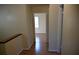 Hallway with neutral paint and laminate wood flooring provides passage to rooms with doors at 3338 York Pl, Decatur, GA 30032