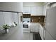 Compact kitchen featuring white cabinets, neutral countertops, and essential appliances at 3338 York Pl, Decatur, GA 30032
