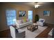Bright living room with neutral furniture, a modern rug, and large windows for ample natural light at 3338 York Pl, Decatur, GA 30032