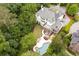 A beautiful backyard oasis is shown with a pool, spa, patio area, and lush, mature landscaping at 948 Saint Lyonn Cts, Marietta, GA 30068
