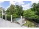 Backyard view from upper deck featuring a black iron railing, trees, a pool and patio furniture at 948 Saint Lyonn Cts, Marietta, GA 30068