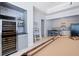 Open concept bar area with wine fridge, bar stools, stainless steel appliances, and light cabinetry at 948 Saint Lyonn Cts, Marietta, GA 30068