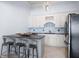 Bright bar area with light cabinetry, backsplash, bar top seating, stainless steel appliances, and recessed lighting at 948 Saint Lyonn Cts, Marietta, GA 30068